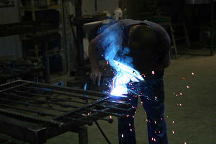 Contractor Supporting Services Welder in a workshop making a fence