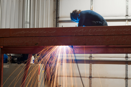 Contractor Supporting Services: Welder working steel structure Hangar